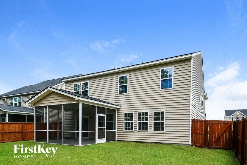 A house with a fence and a clear sky.