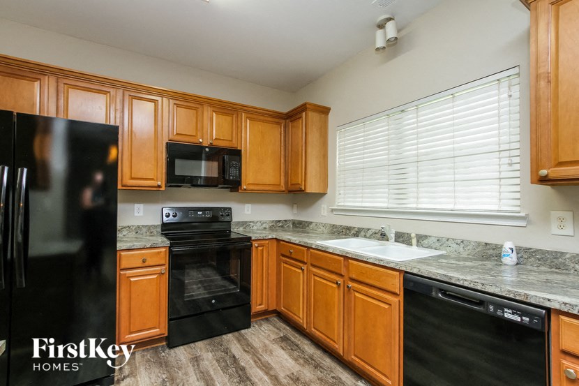a kitchen with black appliances and wooden cabinets