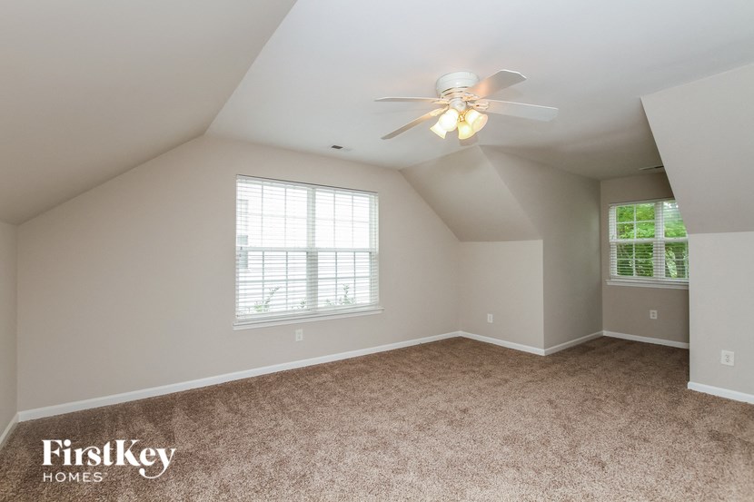 the master bedroom is spacious and has a ceiling fan