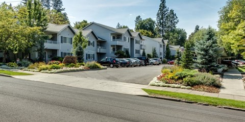 A row of houses with a car parked in front of them.