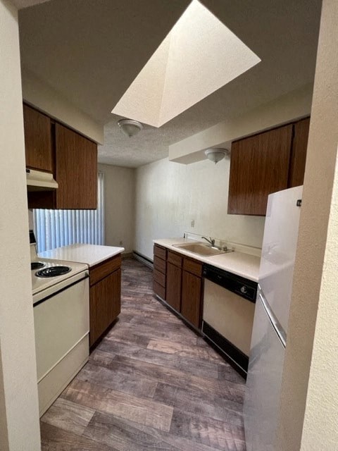 an empty kitchen with a stove and a refrigerator