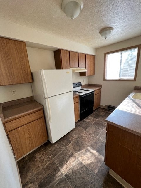 a kitchen with a white refrigerator and a window
