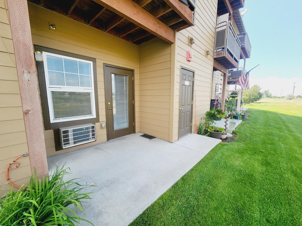 A house with a brown siding and a grey door.