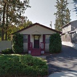 a small white house with a red door