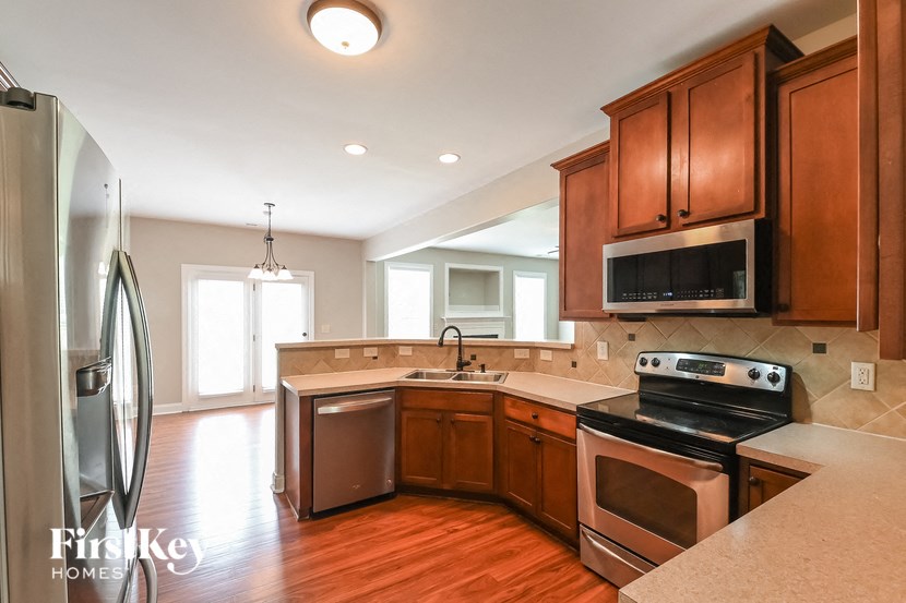 a kitchen with wooden cabinets and stainless steel appliances