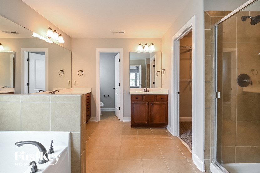 a bathroom with a shower and a sink and a mirror