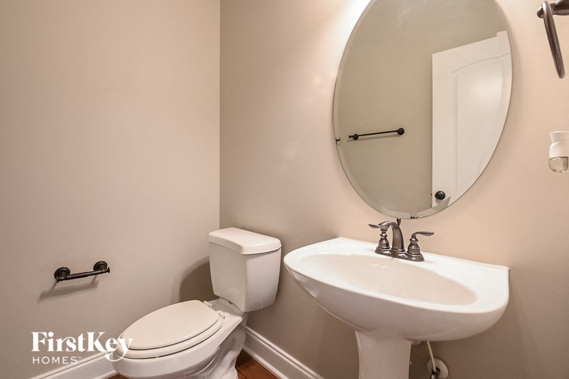 a small bathroom with a sink toilet and a mirror