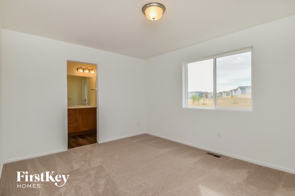 an empty living room with a view of the beach