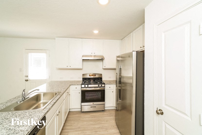 a kitchen with stainless steel appliances and white cabinets