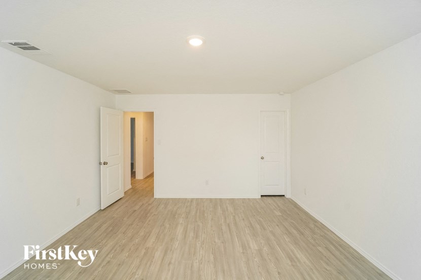 an empty living room with white walls and wood flooring