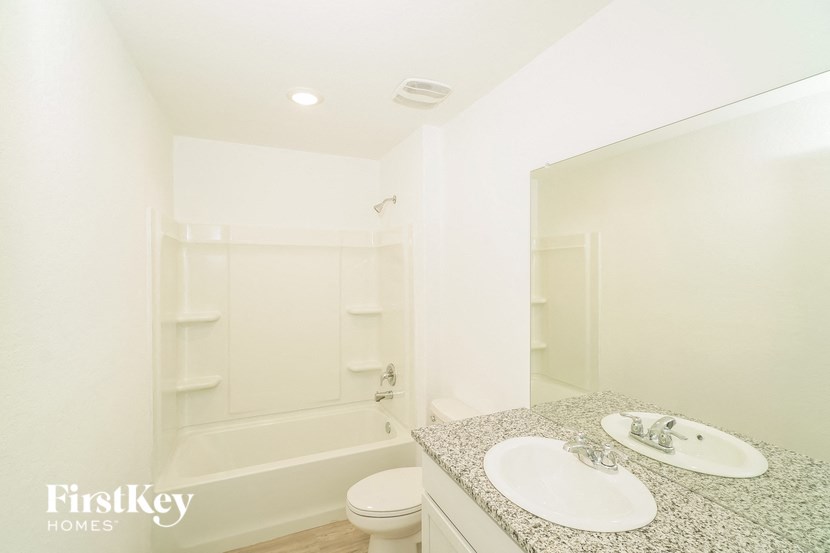 a bathroom with a sink and a toilet and a bath tub