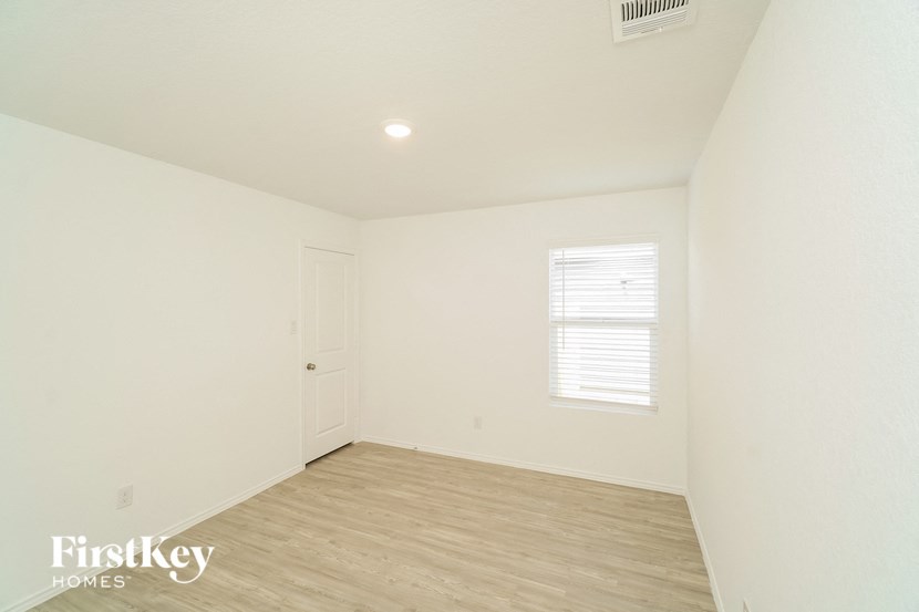 an empty room with a door and a window