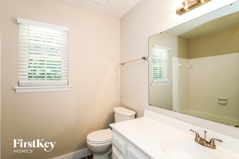 A white bathroom with a FirstKey Homes logo.