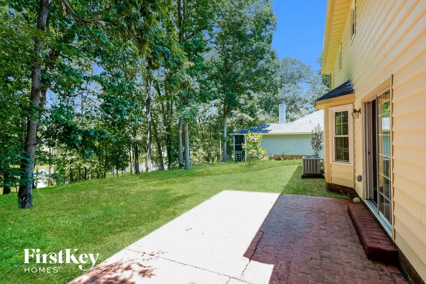 A house with a brick walkway leading to the front door.