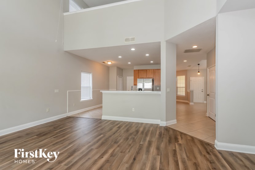 A spacious room with wooden floors and a white ceiling.