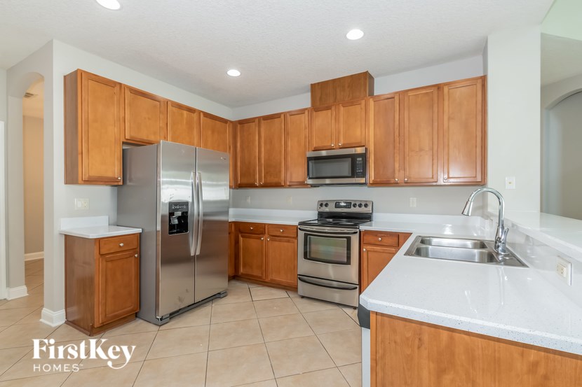 A kitchen with wooden cabinets and stainless steel appliances.