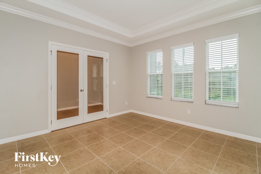A room with a tiled floor and a sliding door.