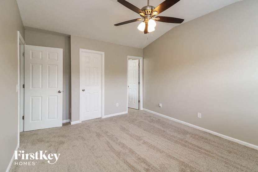 a empty living room with a ceiling fan