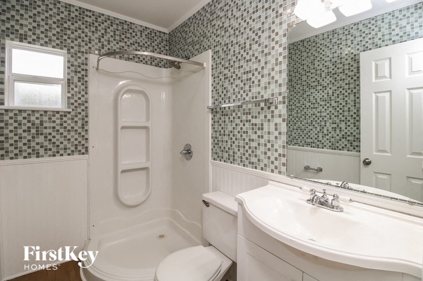a white bathroom with a sink and a toilet