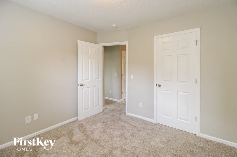 a bedroom with two closets and two doors