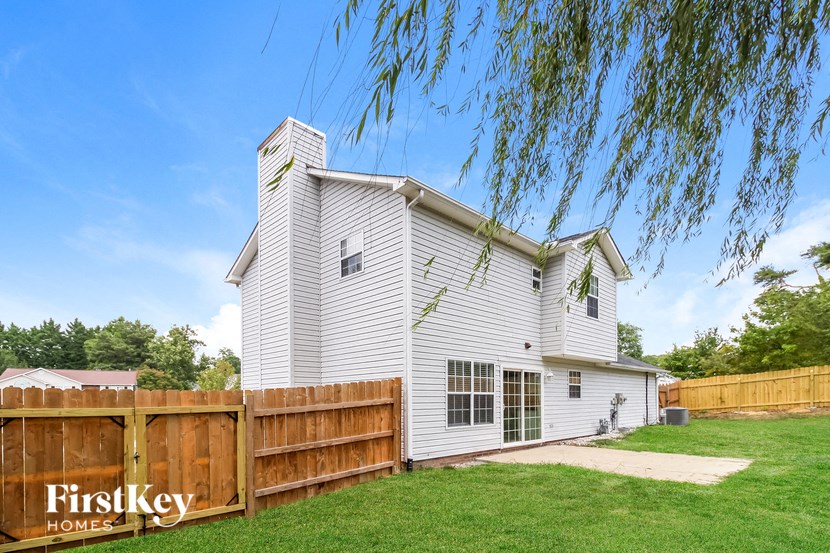 a white house with a wooden fence in front of it