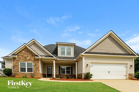 A house with a garage and a driveway is shown.