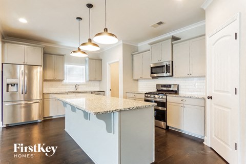 A kitchen with a stove top oven and a microwave.