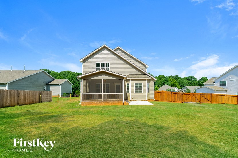 a backyard with a fence and a house