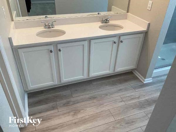 a bathroom with two sinks and a mirror