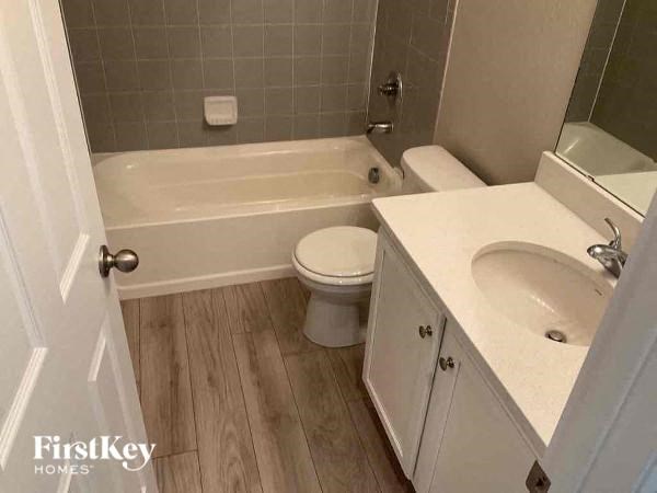 a bathroom with a toilet and a bath tub and a sink