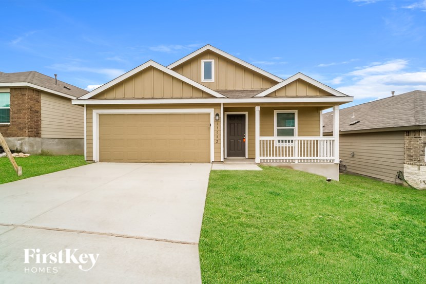 A house with a garage door and a driveway.