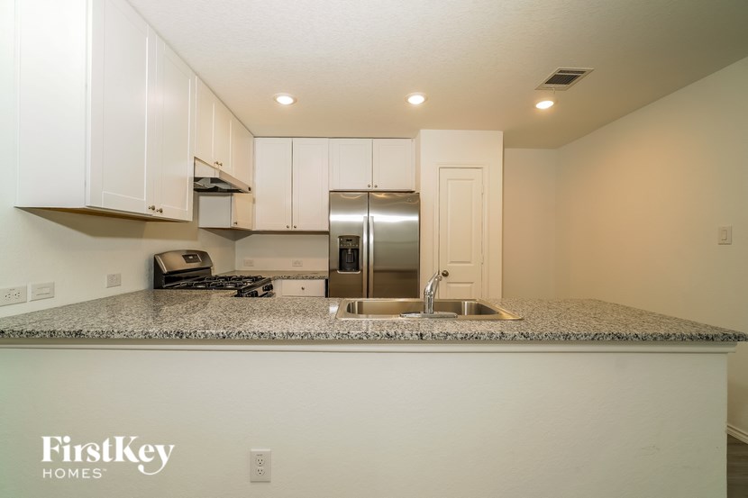 A kitchen with a granite countertop and a sink.