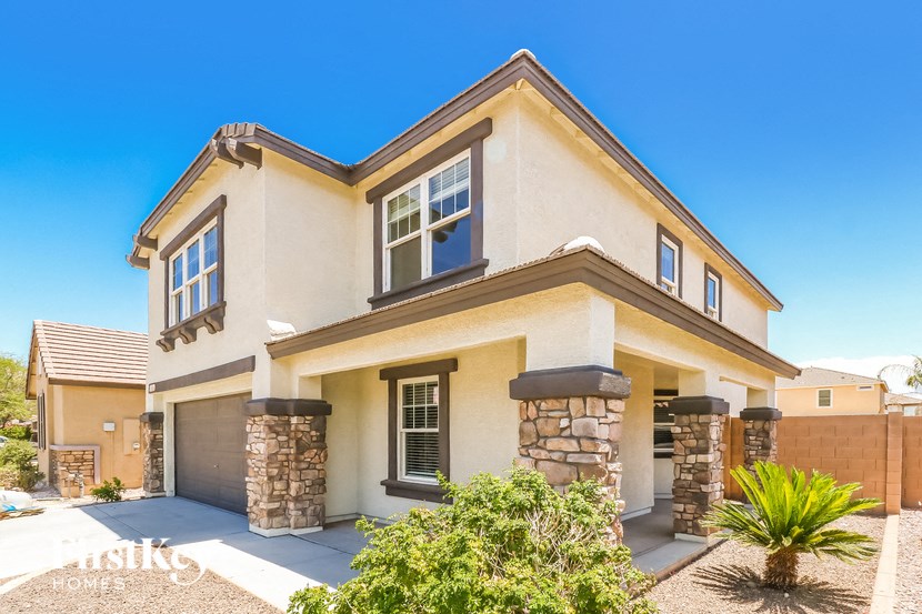 a beige house with a garage and a driveway