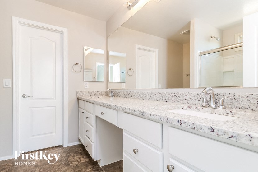 a white bathroom with a sink and a mirror