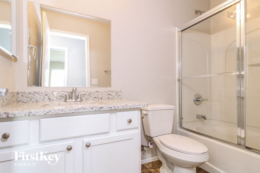 a bathroom with a sink toilet and a shower