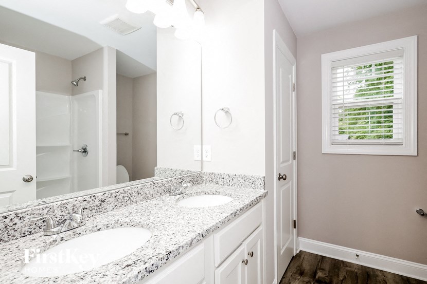 a bathroom with two sinks and a large mirror