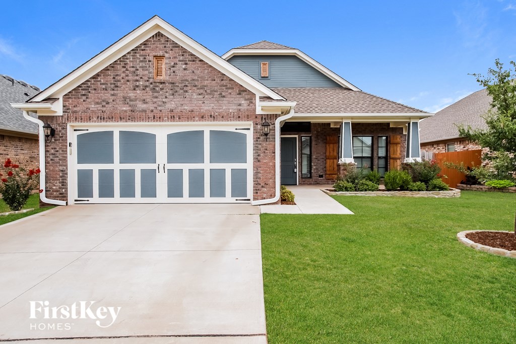 a white garage door on a brick house