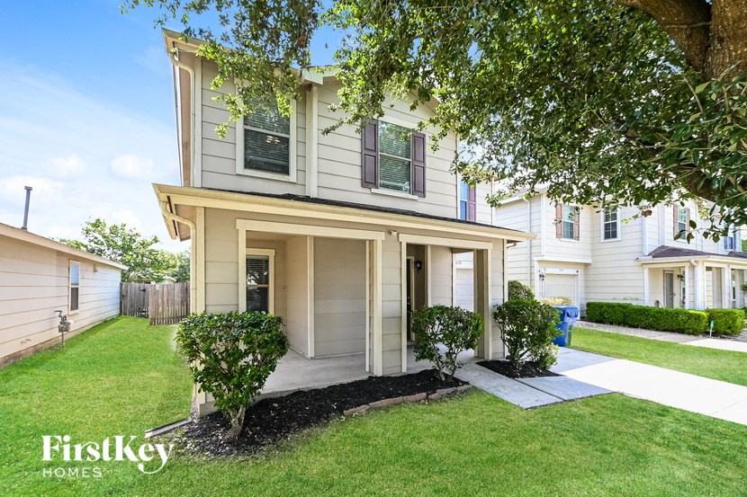 a white house with a lawn and a sidewalk