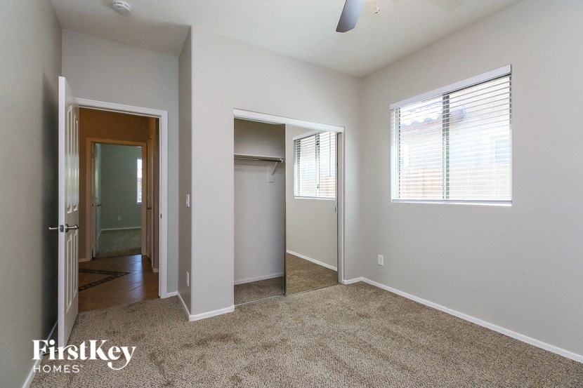 a bedroom with a closet and a door to a hallway