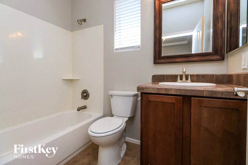 a bathroom with a toilet and a sink and a bath tub