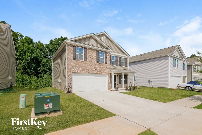 a brick house with a garage and a driveway
