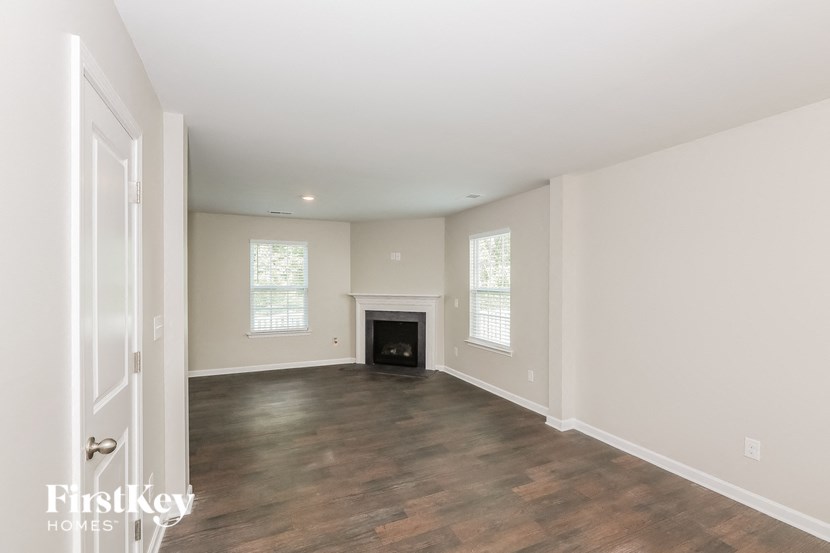 a living room with a fireplace and a wooden floor