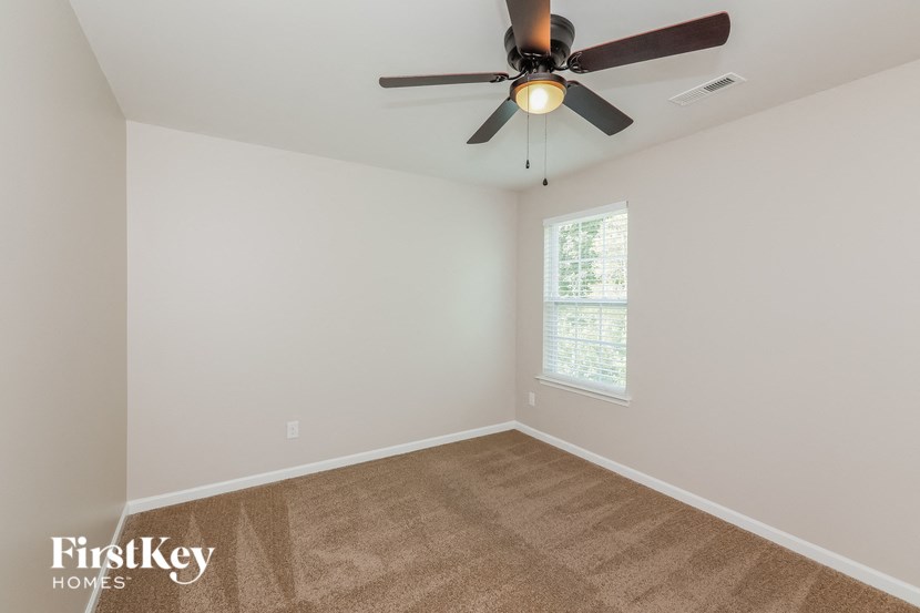 the living room of a home with a ceiling fan