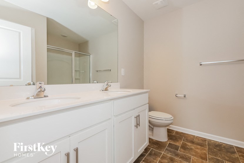 a bathroom with a toilet and a sink and a mirror