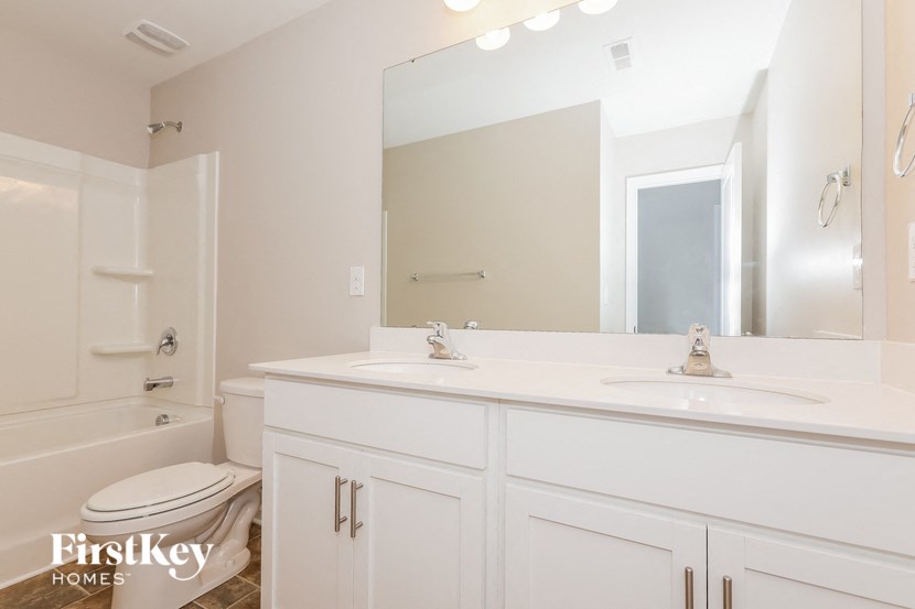 a bathroom with a sink and a toilet and a mirror