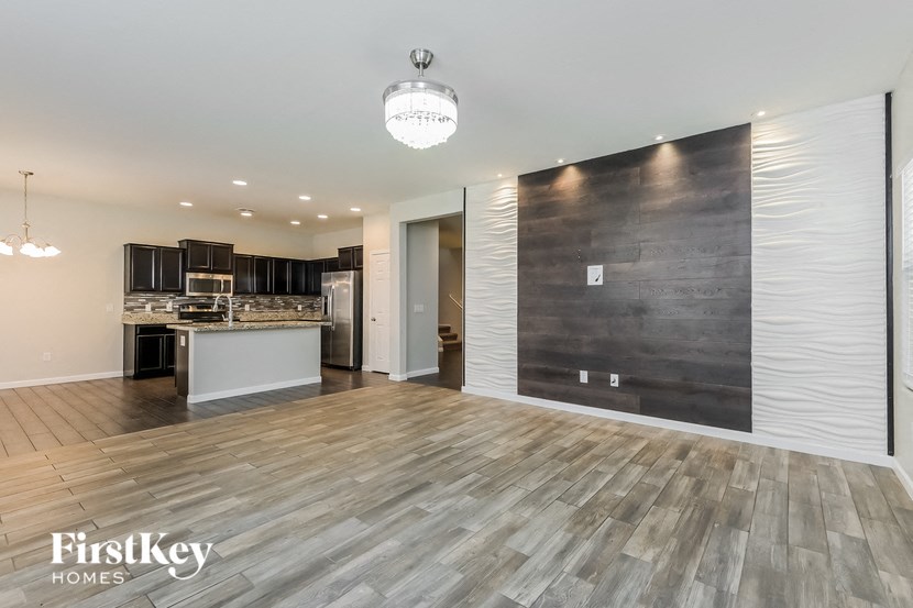A modern kitchen with a wooden floor and a Firstkey Homes logo.