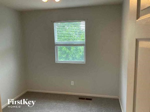an empty room with a window and a door