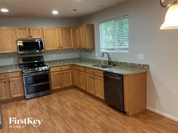 a kitchen with wooden cabinets and stainless steel appliances