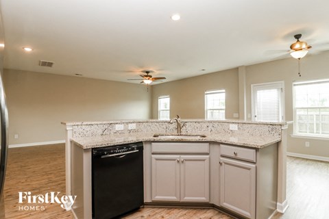 a kitchen with white cabinets and a counter top