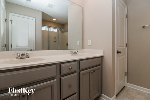 a bathroom with two sinks and a large mirror